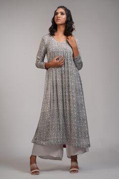 Grey anarkali with floral hand block print and gathered detailing. Paired with palazzo.
Components: 2
Pattern: Hand Block Printed
Type Of Work: Floral
Neckline: V neck
Sleeve Type: Long sleeves
Fabric: Modal Satin
Color: Grey
Other Details: 
Approx weight: 5-7 kgs
Model height: 5ft 9inches, wearing size M
Occasion: Puja - Aza Fashions Anarkali Style Maxi Length Palazzo Set For Reception, Anarkali Palazzo Set For Reception, Designer Anarkali Silver Kurta, Silver Anarkali Kurta For Wedding, Silver Anarkali Set For Eid, Bollywood Silver Salwar Kameez For Eid, Silver Bollywood Salwar Kameez For Diwali, Traditional Silver Designer Dresses, Silver Anarkali Salwar Kameez For Designer Wear