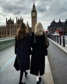 two women walking down the street in front of big ben