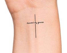 a woman's wrist with the words same by grace written on her left arm