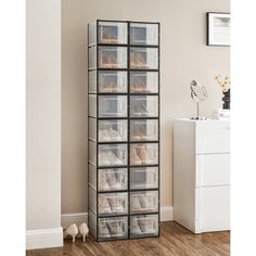 the shoe rack is filled with clear plastic drawers and shoes on top of it, along with other storage bins