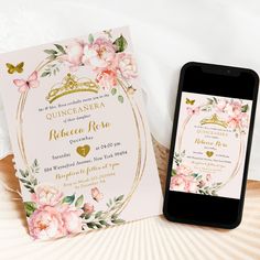 a phone next to a wedding card on a table with flowers and butterflies around it