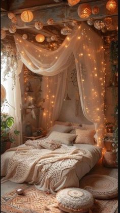 a bed with lights hanging from the ceiling and pillows on the floor in front of it