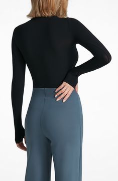 This buttery-soft turtleneck top fits like a second skin thanks to ample stretch that's blended right in. Turtleneck Long sleeves 84% nylon, 16% elastane Machine wash, dry flat Imported Versatile Stretch Turtleneck For Layering, Stretch Long Sleeve Versatile Turtleneck, Versatile Stretch Long Sleeve Turtleneck, Versatile Long Sleeve Stretch Turtleneck, Elegant High Stretch Tops With Thumbholes, Sleek High Stretch Tops For Layering, Elegant Long Sleeve Nylon Tops, Sleek High Stretch Tops With Thumbholes, Versatile High Stretch Turtleneck