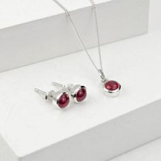 Beautiful and Elegant Jewellery Set with Ruby gemstone made in sterling silver.  Ruby, a red stone, is a stone of passion and desire and bring harmony in life to the wearer. Ruby is the birthstone of July and an ideal gift for 15th marriage anniversary.  The July birthstone jewellery set consists of a pair of delicate earring studs and a chain with charm necklace.  The necklace comes in 16" and 18" fine curb chain Please avoid in contact with chemicals and use silver cloth to clean. Delicate Earring, Elegant Jewellery, Marriage Anniversary, July Birthstone Jewelry, Forever Jewelry, Jewellery Store, Earring Studs, Jewelry Ring Box, Men's Jewelry Rings