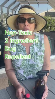 a woman sitting at a picnic table with a bottle of wine in her hand and the words non - tonic 2 ingredient bug repellent