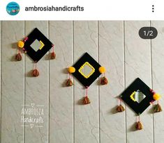 three graduation caps with tassels hanging on the wall