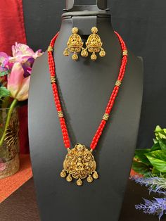 Goddess Lakshmi Coral Beads Haram/Antique Gold Finish / 3 Line Haram  with Matching Earrings/ 24 Inches Long/ Gift jewelry /Indian Jewelry This item is perfect to whear any time for parties and festivals! DETAILS: Includes Only  one haram and 2 Earrings . Necklace: 24 inches. Chain Closer . Weighs 1.80 oz ( 51 g).  Earrings: 1.8 inches Long  width; 1 inch wide  Material: Imitation gold Beads Coral Beads  Antique Gold Finish  Finish: Premium gold finish.  NOTE: I try my best to show you photos of my products as they appear in real life, but please note that variations in color occur due to differences in lighting and screen settings.  PRODUCT CARE: - Avoid contact with heat/fire, water, and chemicals such as perfumes or any sprays to prevent product damage.  - Store wrapped in butter paper, Beads Haram, Butter Paper, Fire Water, 2 Earrings, Black Bead Necklace, Goddess Lakshmi, Jewelry Indian, Coral Beads, Gift Jewelry