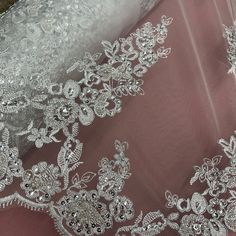 Make your special day even more memorable with our Beaded & Corded Lace Fabric. This luxurious fabric features an elegant pattern of embroidered flowers and pearls, with intricate corded and beaded detailing. Perfect for wedding dresses, evening gowns, quinceanera dresses, and dance costumes, our 100% polyester net mesh fabric has been handmade with the highest quality for a one-of-a-kind look. The fabric is available in 5 stunning colors, and can be ordered in any quantity. For a show-stopping Festive Pearl Embroidered Lace Fabric, Delicate Lace Embroidered Wedding Fabric, White Beaded Lace Embroidered Fabric, Beige Pearl Embroidered Lace Fabric, Quinceanera Crown, Pink Rhinestone-embroidered Lace Fabric, Corded Lace Fabric, Bridal Lace Fabric, Corded Lace