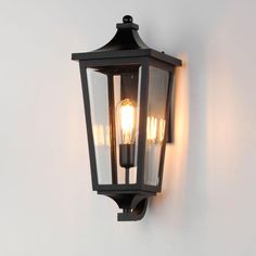 an outdoor light hanging on the wall