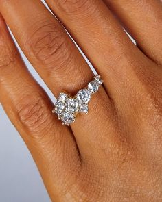 a woman's hand with a diamond ring on it