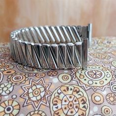 NOS unused 1950s old-stock Foster stainless steel scissor-expansion watch bracelet.  The ends are straight 3/4" (18.8mm), you can file them to 18mm 17.2mm 17mm or 5/8" (just under 16mm).    Spring bars are included, remember to tell us what size you need.  The length at the spring bars is 5 3/8" (137mm).    No removable links.  7E.24948 Vintage Metal Watch Accessories, Vintage Adjustable Metal Watch Accessories, Vintage Silver Watch Band With Stainless Steel Clasp, Vintage Adjustable Silver Watch Bands, Vintage Silver Adjustable Watch Bands, Watch Bracelet, 1950s Vintage, Vintage Watches, Watch Band