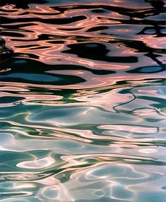 the water is reflecting light from the sun's reflection on it, as well as ripples