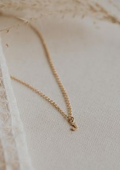 Is there anything sweeter than a tiny single initial? We don’t think so! 8 x 6mm uppercase block letter is suspended from scout chain. Available in 16" or 18". Available in 14kt Gold Fill + Sterling Silver. Kayla layers it with our Pearl Linked Necklace. Handmade in Eau Claire, WI. Our jewelry is handmade so each piece will be unique and may vary slightly from what is pictured. Delicate Everyday Charm Necklaces With Initial Pendant, Delicate Everyday Charm Necklace With Initial Pendant, Dainty Charm Necklaces With Initial Pendant For Everyday, Everyday Tiny Initial Pendant Charm Necklace, Simple Tiny Initial Pendant Charm Necklace, Simple Tiny Initial Pendant Charm Necklaces, Dainty Initial Pendant Necklace For Everyday, Delicate Chain Initial Pendant Necklace, Dainty 14k Gold Filled Initial Necklace For Everyday