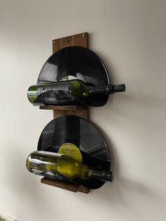 two wine bottles are sitting on the wall