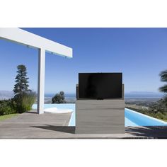 a flat screen tv sitting on top of a wooden stand next to a swimming pool