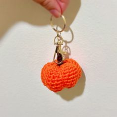 an orange crocheted keychain with a chain attached to it