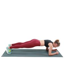 a woman is doing push ups on a mat