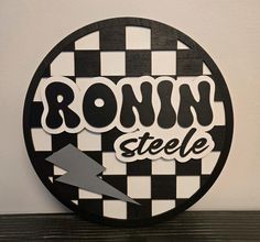 a round sign with the word ronin steele on it and an arrow pointing up