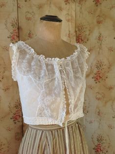 "breath taking fresh antique camisole, wedding top. sleeveless lace summer top in excellent condition. bust 92 cm 36\" waist 66 cm 26\" length 38 cm 15\" the shoulders have ruffled lace and made on them you can see see little roses made of soft silk ribbons" Sleeveless Lace Corset With Lace Top, Lace Trim Sleeveless Corset, Lace Corset With Lace Trim Sleeveless, White Lace Bodice With Lace Trim, Summer Lace Corset With Lace Top Detail, Sleeveless Lace Bodice Summer Corset, Fitted Camisole Blouse For Daywear, Sleeveless Delicate Lace Top For Daywear, Fitted Lace Bodice Camisole For Wedding