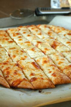 a pizza sitting on top of a pan covered in cheese