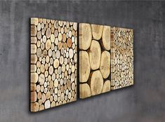 three pieces of wood are displayed on the wall in this modern art piece, which is made out of logs