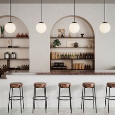 three bar stools in front of a counter with bottles on it