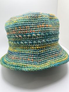 Perfect for looking good and protecting yourself from the sun. Hat is made with multiple strands of yarn including cotton and bamboo. Fits medium to large head. Can be machine washed on gentle cycle and air dried. Spring Bucket Hat With Short Brim, Handwoven, Eco-friendly Curved Brim Bucket Hat For Spring, Eco-friendly Spring Bucket Hat With Curved Brim, Spring Handwoven Brimmed Bucket Hat, Natural Cotton Sun Hat With Short Brim, Green Cotton Hat With Short Brim, Slouchy Crochet Beanie For The Beach, Casual Slouchy Summer Hat, Woven Cap For Beach