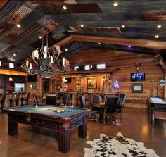 a pool table in a large room with chairs