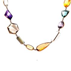 Multi-Gemstone Necklace in 14k Yellow Gold This exquisite modern necklace is crafted from 14 karat yellow gold, creating a luxurious and elegant piece that is sure to spark a conversation. The long piece features a series of multi-gemstone bezel set stones, with a total of 91.52 carats of citrine, 89.96 carats of aquamarine, 80.66 carats of quartz, 79.55 carats of amethyst, 41.31 carats of tourmaline, and 10.20 carats of topaz.  The perfect combination of modern design and luxurious gemstones, t Yellow Gold Briolette Gemstones For Formal Occasions, Formal Yellow Gold Briolette Gemstones, Long Gemstone Necklace For Formal Occasions, Formal Long Gemstone Necklace, Elegant Multi-stone Gemstones In 14k Gold, Luxury Yellow Gold Briolette Gemstones, Luxury Multi-stone Necklaces For Formal Occasions, Exquisite Multi-stone Necklace For Formal Occasions, Luxury Formal Multi-stone Necklace