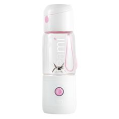 a pink and white baby bottle sitting on top of a table