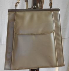 Cream color 1960s vinyl handbag. Outside compartment has magnetic clasp. Inside is lined with cotton/linen and has 1 zippered side compartment. Strap is adjustable. I can just see this with a pair of go go boots. 10 in tall 30 1/2 in tall with handle at longest 10 1/2 wide at bottom 8 in wide at top 2 1/2 in deep at bottom I will ship internationally - just need your postal code to calculate cost. Check out my handmade clothing at kissmyattitude.etsy.com Vintage Cream Bags For Vintage Events, Vintage Cream Bags, Vintage Cream Satchel Bag, Ladies Writing Desk, Go Go Boots, Cottage Decor Farmhouse, Postal Code, White Purse, Hand Thrown Pottery