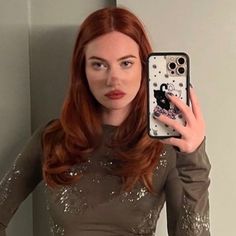 a woman is taking a selfie in the mirror with her cell phone and wearing a sequined top