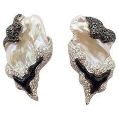 Pearl, Black Diamond 1.20 carats and Diamond 1.81 carats Earrings set in 18 Karat White Gold Settings Width: 2.5 cm Length: 4.5 cm Total Weight: 33.18 grams "We first opened doors in 1980 when it was then situated in the vicinity of the Victory Monument; a small and modest storefront with a couple of counters. From its humble beginnings to where it stands today, our company has proven its abilities as a jeweler. Since the beginning, we have been supplying fine quality pieces to dealers, wholesal Luxury Black Diamond Earrings For Anniversary, Luxury Black Diamond Earrings, White Gold Diamond Earrings, Marquise Shape Diamond, White Gold Set, Pearl And Diamond Earrings, Gold Diamond Earrings, White Gold Earrings, Brown Diamond