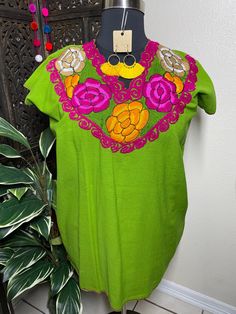 "A very nice and beautiful Blouse w/Gorgeous Embroidery. The design work is simply gorgeous. Perfect for your ultimate weekend look, beach, casual look or just to impress your friends with this gorgeous piece. You will Love it! Blouse STYLE DETAILS Overview * V neck * Handmade work Measurements: **XL Green: 33\" Long (shoulder to hem) 24.5\" Wide (underarm to underarm) **XL Orange: 33\" Long (shoulder to hem) 24.5\" Wide (underarm to underarm) **1X Purple: 33\" Long (shoulder to hem) 28\" Wide ( Green Embroidered Top For Summer, Green Floral Embroidered Crew Neck Blouse, Green Embroidered Crew Neck Blouse, Green Crew Neck Blouse With Floral Embroidery, Festive Traditional Tops With Tonal Embroidery, Traditional Short Sleeve Blouse With Tonal Embroidery, Green Floral Embroidered Fabric Long Sleeve, Festive Green Top With Floral Embroidery, Festive Green Embroidered Dress With Floral Detail