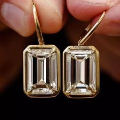 Dangle Drop Earrings Gift, 12x8MM Emerald Brilliant Cut Moissanite Wedding Earrings, Bezel Set In 14k Yellow Gold Latch Back Bridal Earrings ✹✹𝐖𝐞𝐥𝐜𝐨𝐦𝐞 𝐭𝐨 𝐂𝐫𝐚𝐳𝐲𝐃𝐢𝐚𝐦𝐨𝐧𝐝𝐬𝐂𝐨✹✹ Detail about stones Moissanite & Simulated Stone: ----------------------------- Stone Shape: Emerald Cut Stone Size: 12x8 mm Weight: 10.68 TCW Color: Colorless Cut: Excellent Clarity: VVS ★ 𝑰𝒕𝒆𝒎 𝑫𝒆𝒕𝒂𝒊𝒍𝒔:- ☛ Metal Purity: Solid Gold (10KT, 14KT, 18KT); Silver(925 Sterling, 935 Argentium), 950 Emerald Cut Earrings, Emerald Drop Earrings, Earring Bridal, Emerald Earrings Drop, Bridal Earring, Bezel Set Earrings, Earrings Emerald, Bezel Earrings, Ring Bezel