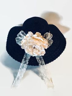 "A beautiful cream satin flower with beads & a cream lace ribbon embellish this black wide brim hat.  A perfect accessories for weddings, church or the Kentucky Derby.  It is a once size fits most.   Measures 17\" across." Black Brimmed Mini Hats For Garden Party, Elegant Beach Hats With Handmade Flowers, Elegant Flower Mini Hats For The Beach, Elegant Flower Mini Hats For Beach, Black Wide Brim Hat, Ladies Dress Hats, Spring Hat, Spring Hats, Dress Hat