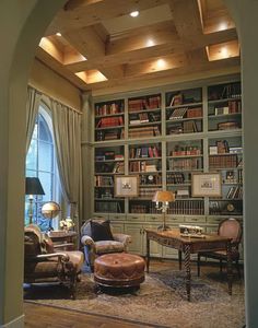 a living room filled with lots of furniture and bookshelves