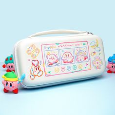 an electronic device with cartoon characters on the front and sides, sitting next to small toy figures