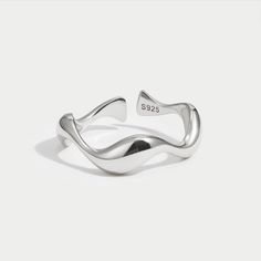 Simple but stunning, these minimalist rings were inspired by the ocean waves. Beautiful on their own or stacked for a unique look, the choice is yours. Silver-plated, brass Adjustable - fits ring size US 5-7 or 8-10 Hypoallergenic, lead & nickel free US/Canada Ring Size UK/AU Ring Size Inside Diameter (mm) 5 J 15.7mm 6 L 16.6mm 7 N 17.2mm 8 P 18.1mm 9 R 19.1mm 10 T 19.7mm If you aren't in LOVE with your purchase, please let us know within 30 days of receiving your item, and you'll receive a stress-free refund. Trendy Adjustable Sterling Silver Midi Rings, Minimalist Wavy Rings As A Gift, Minimalist Wavy Rings For Gift, Minimalist Wavy Rings As Gifts, Adjustable Wavy Rings With A Modern Twist, Modern Silver Wavy Rings, Adjustable Wavy Rings As A Gift, Minimalist Sterling Silver Wavy Ring, Minimalist Stackable Wavy Rings