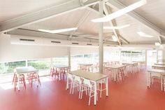 an empty restaurant with tables and chairs in it's red carpeted flooring