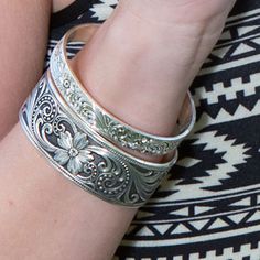 This fully engraved, slim cuff bracelet reflects the simplistic and natural qualities of a western lifestyle. Delicate and beautiful, the antiqued silver finish highlights the engraved artistry for a fashion that transitions easily from casual to evening wear. Perfect for layering with other bracelets. Luxury Engraved Sterling Silver Ornate Bracelet, Luxury Engraved Antique Silver Sterling Bracelet, Etching Jewelry, Leather Tooling Patterns, Cowgirl Accessories, Tooling Patterns, Western Lifestyle, Western Jewelry, Crafted Jewelry