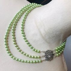 Handcrafted triple strand light green Czech glass Pearl cz clasp necklace, high quality Czech glass pearls in a light green tone, elegant box clasp set in silver plate with clear cubic zirconia stones, silver spacers, one of a kind elegant statement piece, 16"; 18" and 20" strands.  6976 Elegant Green Double Strand Jewelry, Formal Green Pearl Necklace With Round Beads, Elegant Lime Green Jewelry With Round Beads, Elegant Lime Green Beaded Jewelry, Formal Green Pearl Necklace, Green Tone, Clasp Necklace, Box Clasp, Accessories Jewelry Necklace