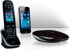 two cell phones and a remote control sitting on a table next to eachother