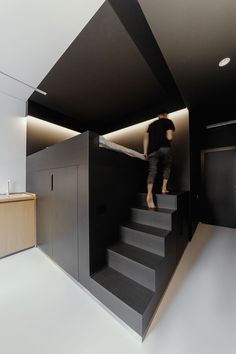 a person climbing up some stairs in a room