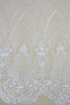 the back side of a sheer curtain with white beads and sequins on it