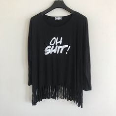 Fringe Tee “Oh Shit!“ Color:Black One Size Made In Usa Brand New Black Long Sleeve Shirt With Text Print, Trendy Black Top With Fringe, Trendy Black Fringe Top, Black Stretch Top With Text Print, Stretch Cotton Blouse With Graphic Print, Casual Black Fringe Tops, Black Cotton Blouse With Graphic Print, Black Graphic Print Crew Neck Blouse, Long Sleeve Slogan Tops For Summer