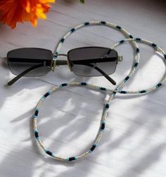 Keep your glasses secure in style with this Silver, Blue, and Black Beaded Eyeglass Chain, a chic seed bead string perfect for readers or sunglasses. This elegant eyewear accessory makes a thoughtful gift idea for Mom or anyone who loves a touch of sophistication in their daily essentials.  This beaded eyeglass chain is the perfect addition to your accessories! Not only is it a glasses chain, it is interchangeable and functions as a beautiful lanyard or even an earbud chain.  Included in your pu Beaded Eyeglass Chain, Gift Idea For Mom, Glasses Holder, Eyeglass Chain, Glasses Chain, Eye Wear Glasses, Bead Stringing, Eyewear Accessories, Daily Essentials