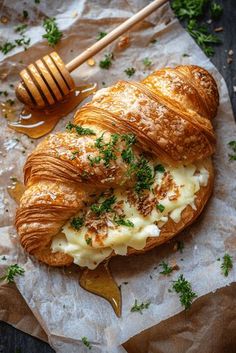 a croissant with butter and parsley on top