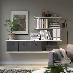 a living room filled with furniture and bookshelves next to a wall mounted painting