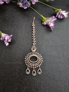 Elegant CZ maang tikka. Made with premium American diamond / cubic zirconia stones. Beautiful rose gold plating. Tikkas are a must have hair accessory for brides and guests alike. Pair this tikka with beautiful statement earrings to add glamour to your wedding outfit. Length (not including chain) - 2 Inches Width - 1.25 Inches ----------- CARE ----------- - Store in air tight zip lock bags - Do not expose to moisture/water - Do not spray chemicals or perfumes on the jewelry Please feel free to contact us if you have any questions. * We sell high quality imitation jewelry only. All measurements are approximate. Please note that all sales are final. Thank you Silver Maang Tikka, Indian Hair Jewelry, Pakistani Jewelry Bridal, Diamond Tikka, Silver Hair Accessory, Maang Tikka, Bridal Hair Jewelry, Indian Hair, Bride Hair Accessories